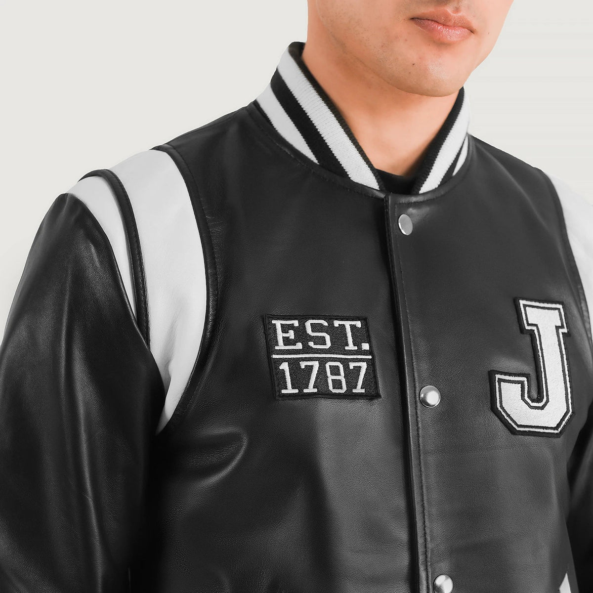 Close-Up Detail of Varsity &amp; Snap Button Hardware on Liberte New Jersey Black Leather Varsity Jacket